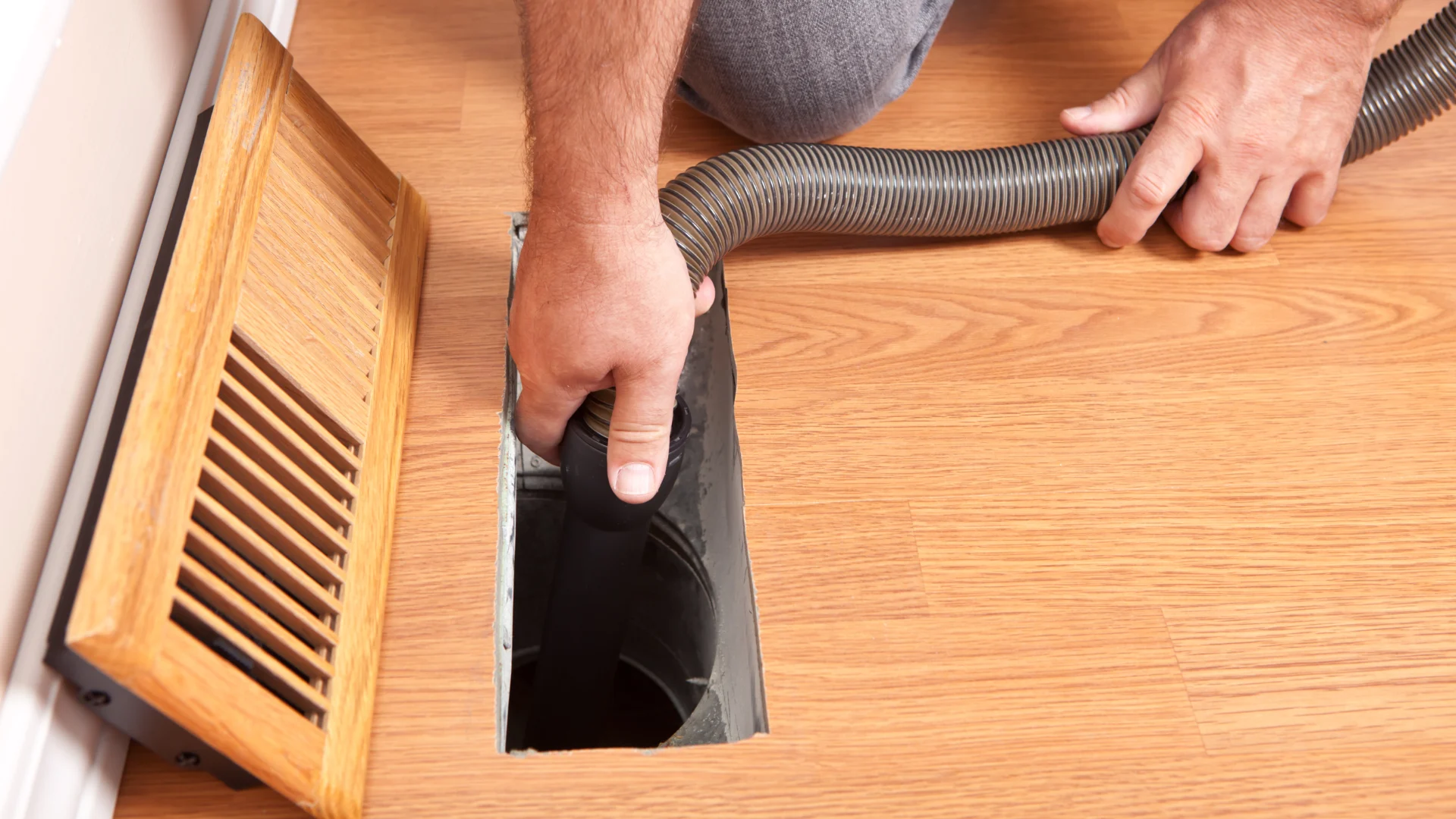 Cleaning hose at a residential floor vent