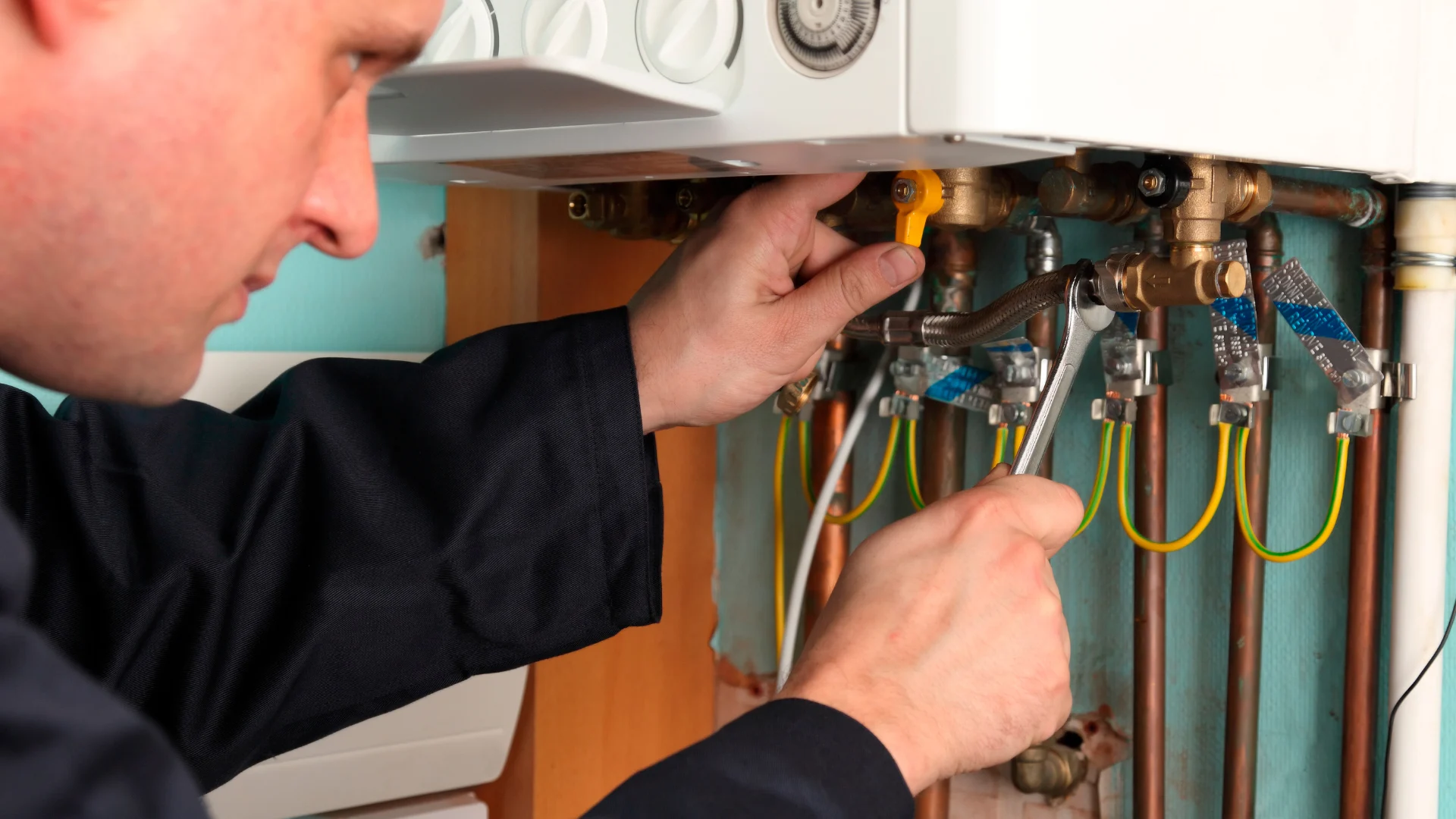 Technician servicing internal boiler components